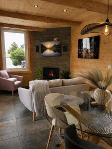 a living room with a couch and a fireplace at CHALET COSY A LA MONTAGNE AVEC SAUNA TONNEAU situé à St Laurent en Grandvaux - Proche lacs cascades et pistes de ski in Saint-Laurent-en-Grandvaux