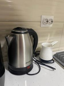 a kettle and a tea pot on a counter at Rena Comfort Apartment in Bar
