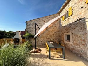 a patio with a table and a brick building at Casa Viva in Umag