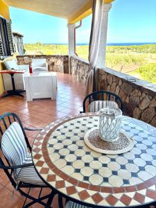 a table and chairs on a patio with the ocean at Villa Relax in Santa Lucia
