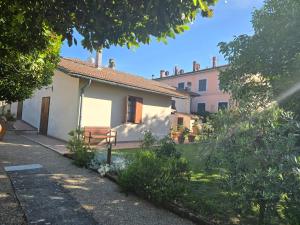 a house with a bench in front of it at La Primavera B&B in Volterra