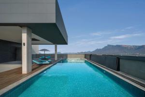 a swimming pool on the roof of a building at Courtyard By Marriott Tirupati in Tirupati
