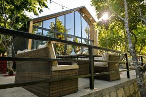 a patio with two chairs and a glass house at Verde Motsameta in Motsameta