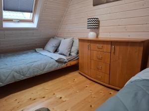 a room with two beds and a cabinet and a window at Domek nad morzem Jerzyk 506-385-791 in Stegna