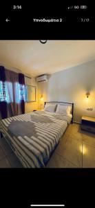 a large bed in a bedroom with a window at the grape house1 in Kalives Poligirou