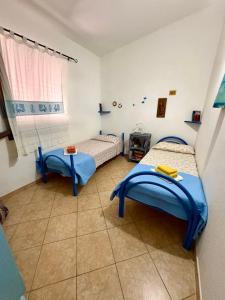 a room with two beds and a window at Villa Relax in Santa Lucia