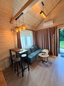 a living room with a couch and a table at Las Się Żyje in Lutowiska +86 photos