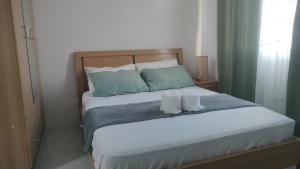a bedroom with a bed with two towels on it at Homey Studio Apartment in Mandaue in Mandaue City +4 photos