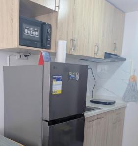 a kitchen with a refrigerator and a microwave at Homey Studio Apartment in Mandaue in Mandaue City