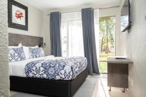 a bedroom with a bed and a large window at 157 on North-Sandton in Johannesburg +172 photos