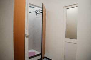 a closet with a glass door and a mirror at Backpacker Hostel Kruje in Krujë +43 photos