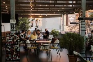 a group of people sitting at a table in a restaurant at Backpacker Hostel Kruje in Krujë