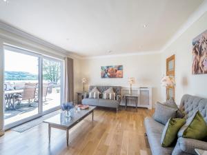 a living room with a couch and a table at Duck Bay Cottage 2 - Uk43935 in Balloch