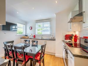 a kitchen with a table and chairs in a kitchen at Duck Bay Cottage 2 - Uk43935 in Balloch