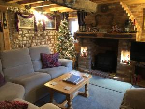 a living room with a christmas tree and a couch at Honey Pots in Foulden
