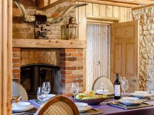 a table with a table cloth and a table with wine glasses at Honey Pots in Foulden