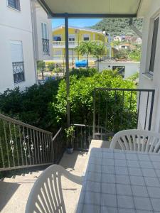 a table and chairs on the balcony of a house at Rena Comfort Apartment in Bar