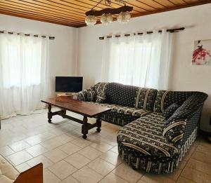 a living room with a couch and a coffee table at Villa Sofia in Mesimvría