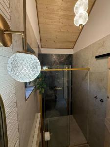 a bathroom with a shower with a glass shower stall at Las Się Żyje in Lutowiska