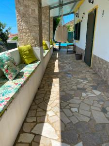 a patio with a couch on the side of a house at Casa dos Avós in São Brás de Alportel