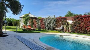 a swimming pool in a yard with a fence at lamaison-d'ose in Romans
