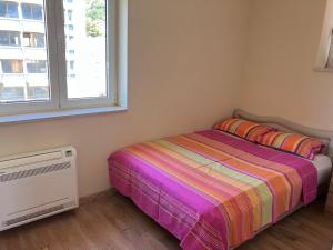 a small bedroom with a bed and a window at Downtown Apartment in Kotor