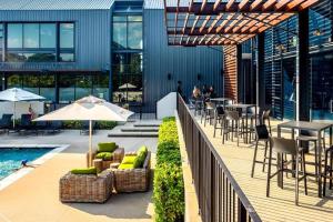 a patio with tables and chairs and a pool at Luxury Apartment Overlooking the River in Midrand