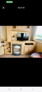 a kitchen with a microwave and a tv in it at Caravan 63 Fishguard Holiday Park in Fishguard