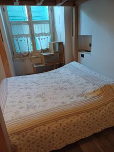 a bedroom with a large bed and a window at Ca' antica B&B in Rovereto
