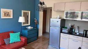 a kitchen with a red chair and a refrigerator at Downtown Apartment in Kotor +16 photos