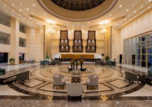 a lobby of a hotel with chairs and a table at Tropitel Sahl Hasheesh in Hurghada +72 photos