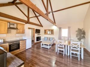 a kitchen and living room with a table and chairs at Westfield Courtyard - Uk50704 in Garton +11 photos