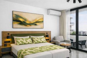 a bedroom with a bed and a chair at Raya Boutique in Sunny Beach