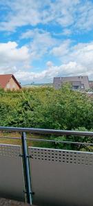 a bench on a balcony with a view of a field at Stilvolle Wohnung in Waldbrunn in Waldbrunn