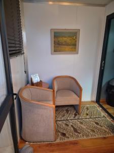 a chair sitting in a corner of a room at Stil Karoo in Montagu +2 photos
