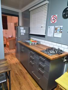 a kitchen with a stove and a refrigerator at Stil Karoo in Montagu