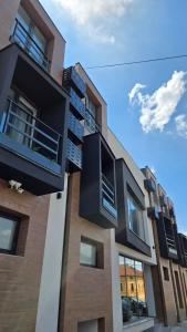 a building with balconies on the side of it at Galerija Odzaci in Odžaci