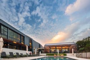 a swimming pool in front of a building at Luxury Apartment Overlooking the River in Midrand +27 photos