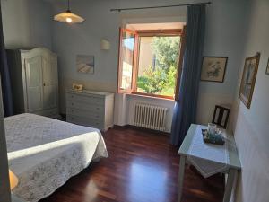 a bedroom with a bed and a window and a table at La Primavera B&B in Volterra +29 photos
