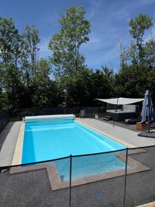 a large swimming pool with aicrobialicrobialicrobialicrobial at Loray des Bois - Cabane - Tipi - Cottage in Loray