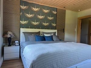 a bedroom with a large bed with blue pillows at Bella's Eden in Grimma