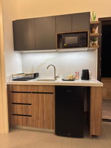 a kitchen with a sink and a microwave at Railway Studio 1 - Cozy Studio in Byblos - Central Location in Jbeil