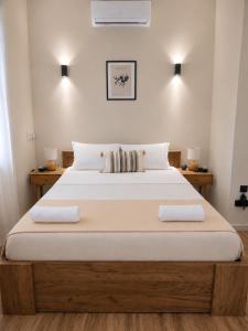 a bedroom with a large bed with two pillows at Mi Casa Chios in Chios