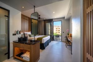 a hotel room with a bed and a desk with a sink at Anesea City in Heraklion +54 photos