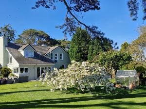 a house with a bunch of flowers in the yard at Drumee Lodge boutique B and B, Newcastle, County Down in Newcastle