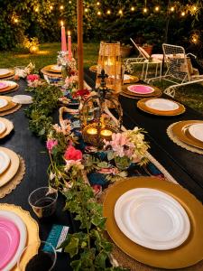 a table with plates and candles and flowers on it at House Garden Loft in Baricella +89 photos