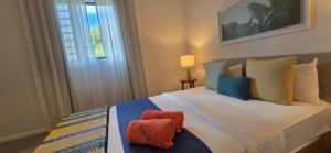 a bedroom with a large bed with two towels on it at Holiday - Comfort - Spacious - Escape in Grand-Baie +17 photos