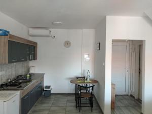 a kitchen with a small table in the middle at City Nest in Vršac
