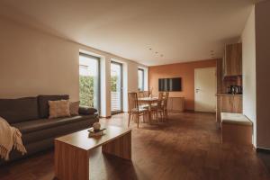 a living room with a couch and a table at Apartments Obernosterer in Kaprun