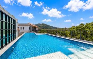 a swimming pool on the balcony of a house at The Title Residencies Naiyang in Phuket